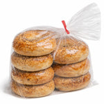Bagels stacked inside a clear plastic bag on a white background