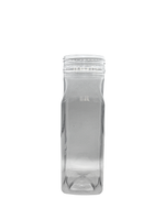 Clear glass bottle with a ribbed texture on a white background
