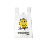 White plastic bag with a smiley face and text on a white background