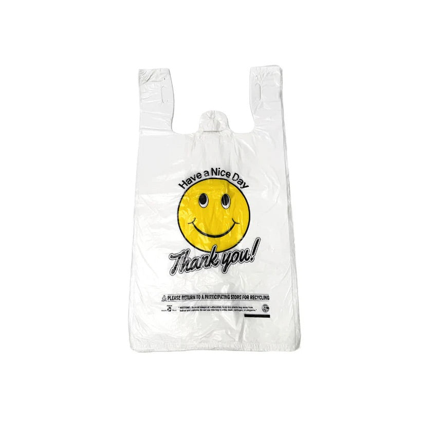 White plastic bag with a smiley face and text on a white background