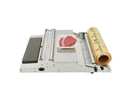 Packaging machine with a roll of paper and a piece of meat on a white background